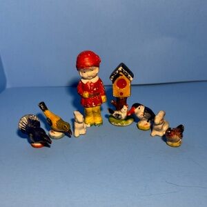 Vintage Japan Bisque figurines featuring a little boy, bird house, and animals